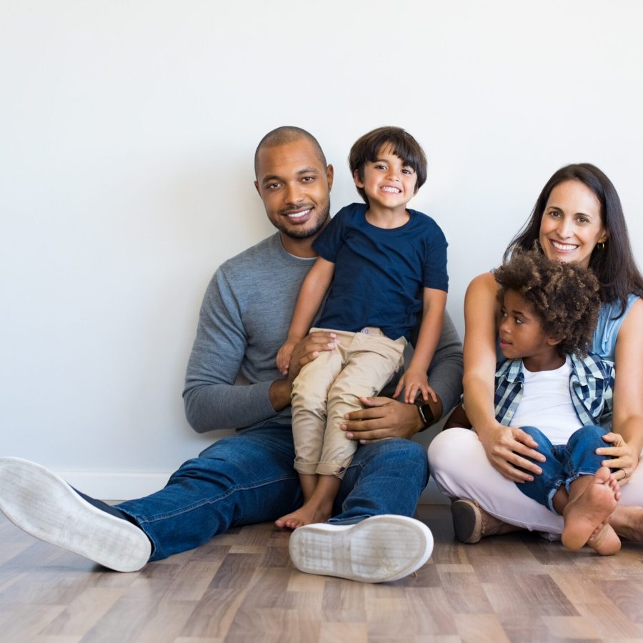 Mixed-family-sitting-together-on-floor-2500x1660